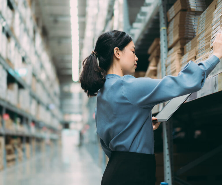 A woman sorting order out in a warehouse